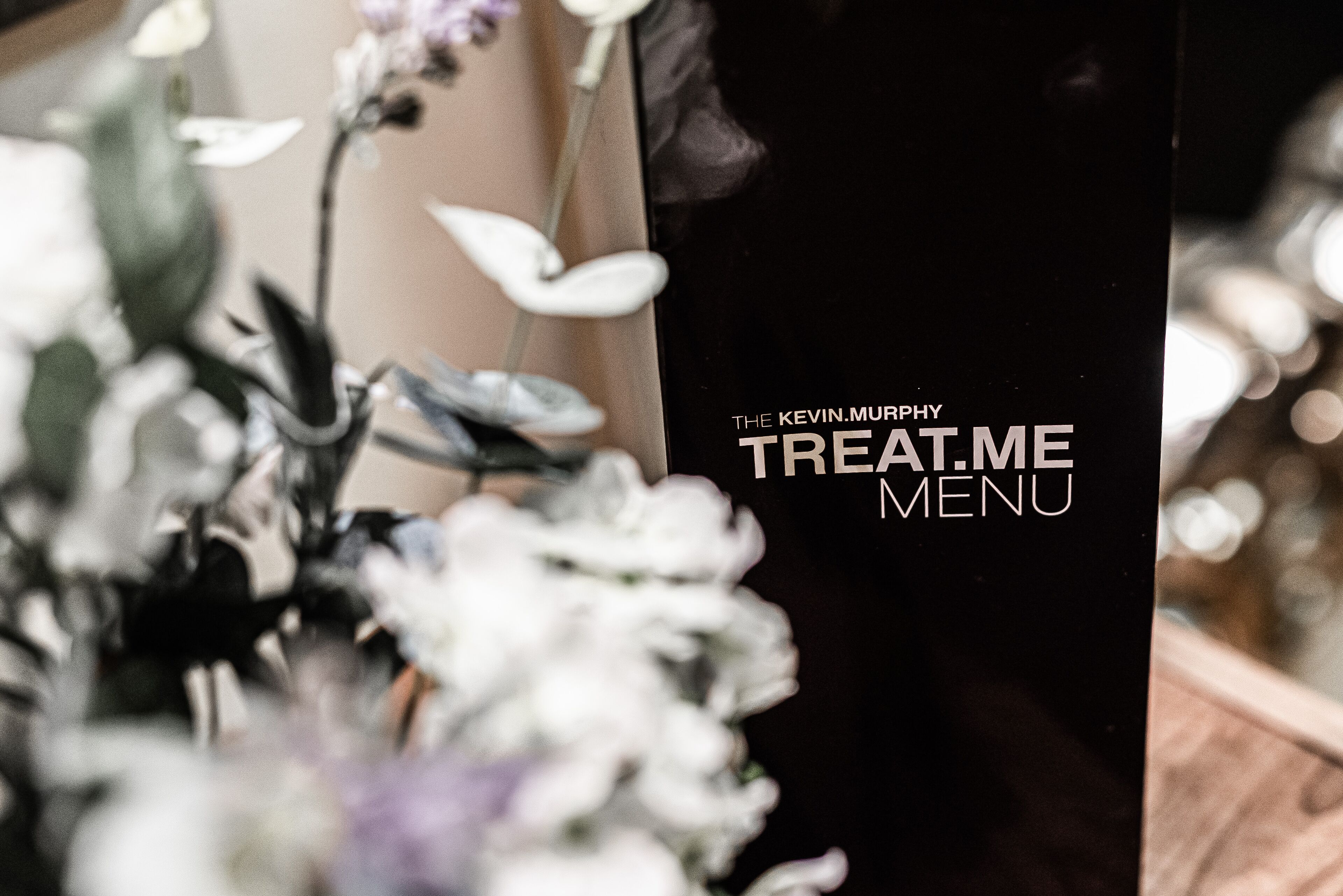 A black menu board with the text "The Kevin Murphy Treat Me Menu".