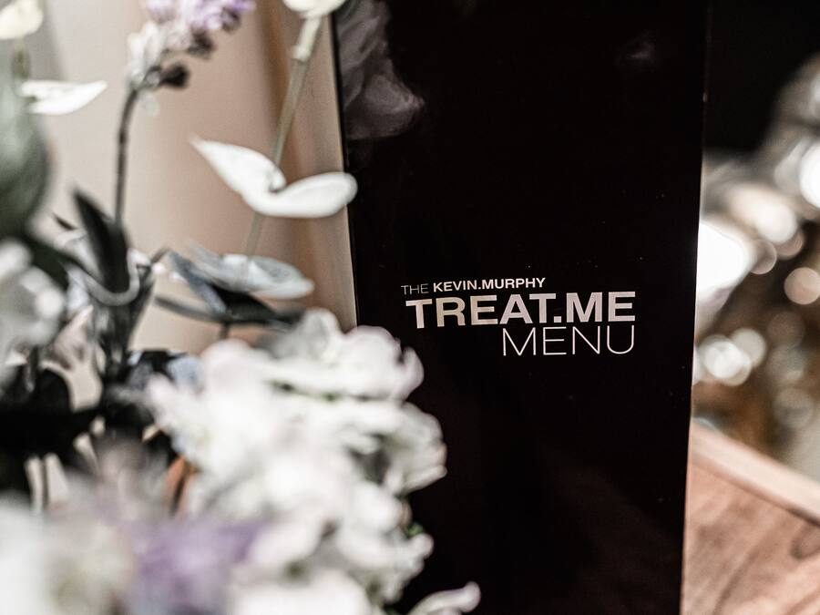 A black menu board with the text "The Kevin Murphy Treat Me Menu".