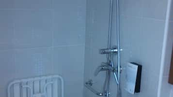A small bathroom with a shower, a toilet, and a sink.