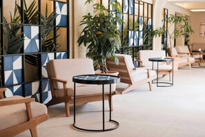 Relax in a stylish lounge area with comfortable seating and potted plants.