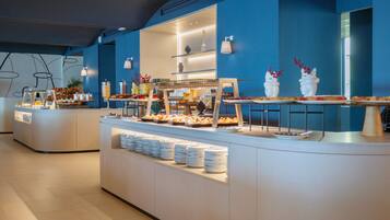 A buffet area with various food items and a counter with plates.