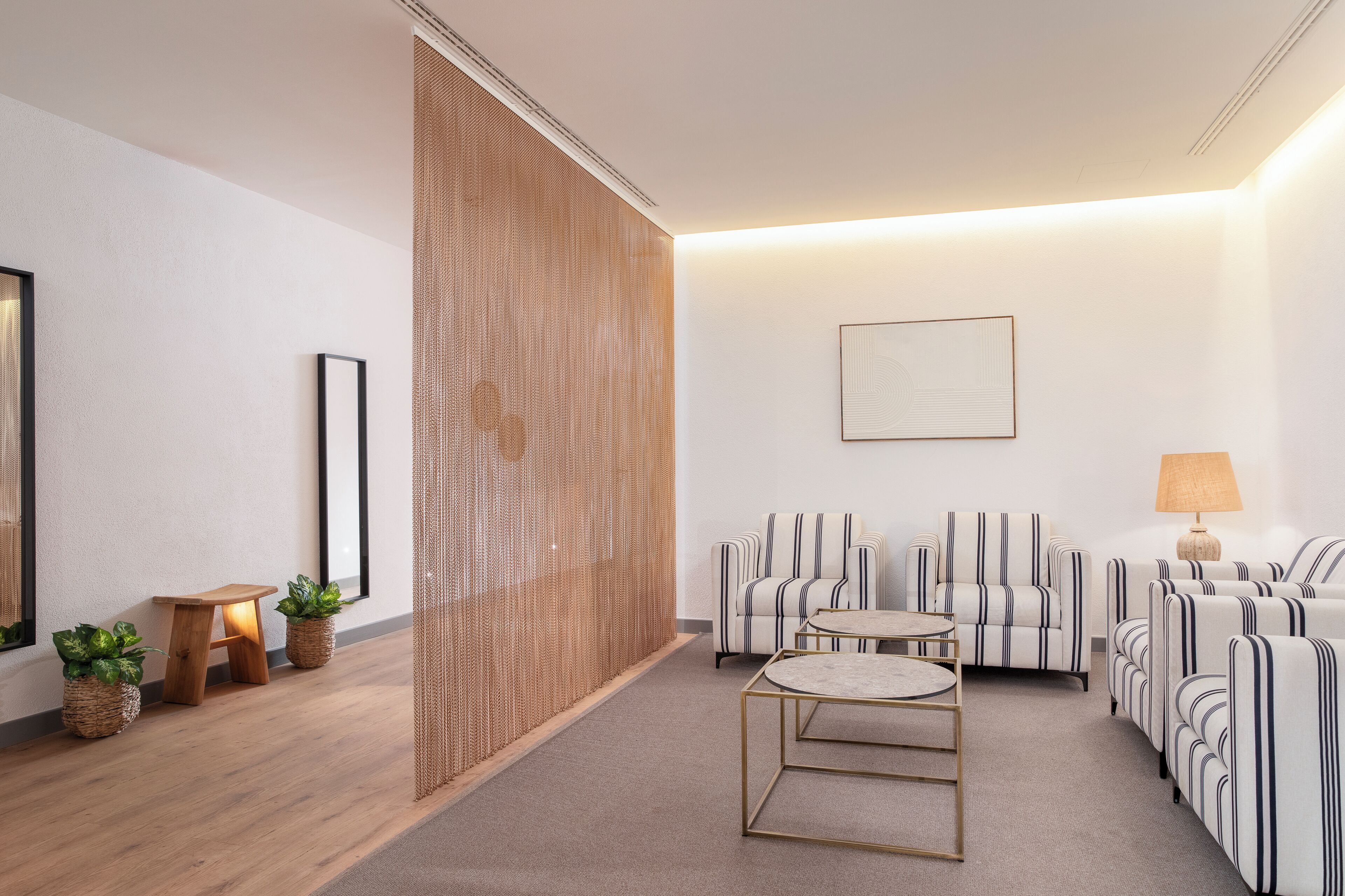 A modern living room with a sofa set, a coffee table, and a small wooden stool.