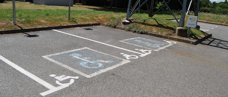 A parking area with disabled parking spaces and a pedestrian crossing.