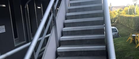 A staircase with metal railings leading to a building entrance.