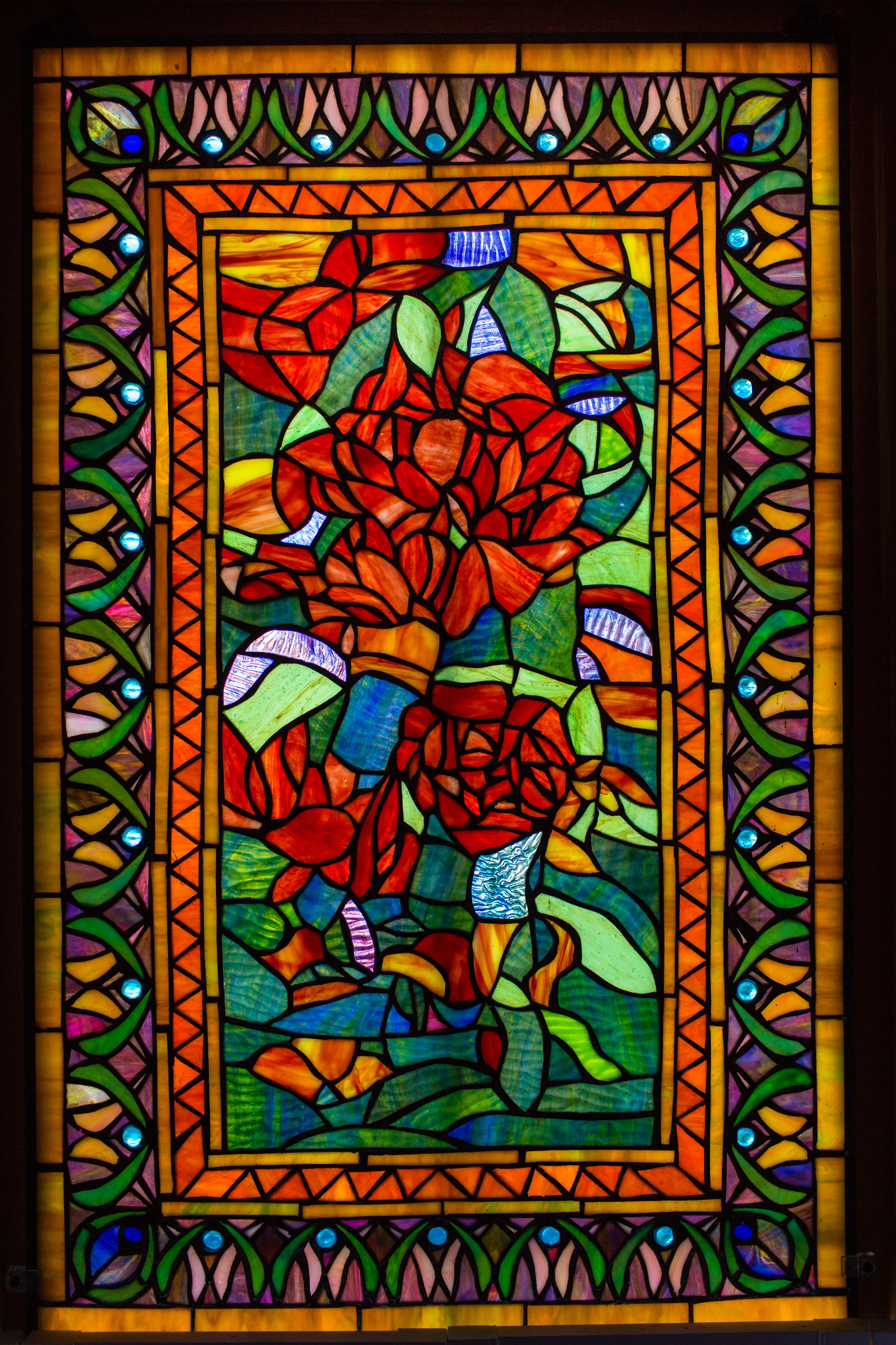 A stained glass window with floral patterns.