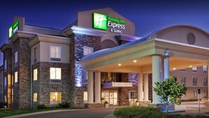 A Holiday Inn Express & Suites building with a stone facade, large entrance canopy, and a well-lit exterior. - Holiday Inn Express Hotel & Suites East Wichita I-35 Andover by IHG (Andover)