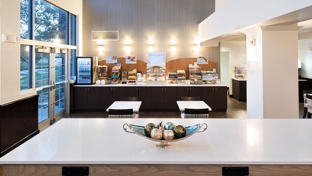A modern breakfast bar with a variety of food options, including cereal, fruit, and bread. - Holiday Inn Express Hotel & Suites East Wichita I-35 Andover by IHG (Andover)