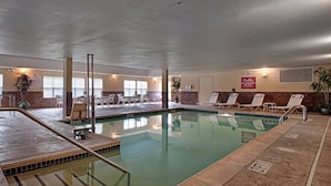 An indoor swimming pool with lounge chairs and a lifeguard sign. - Residence Inn by Marriott Neptune at Gateway Center (Neptune City)