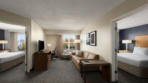 A hotel room with two beds, a sofa, a desk, and a TV. - Residence Inn by Marriott Neptune at Gateway Center (Neptune City)