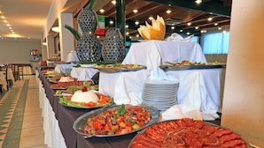 A buffet table with various dishes, including a large platter of sliced meats, a salad, and other food items. -  Fruit Village Crotone Casarossa (Crotone)