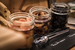 Three glass jars with different contents on a black tray with text.