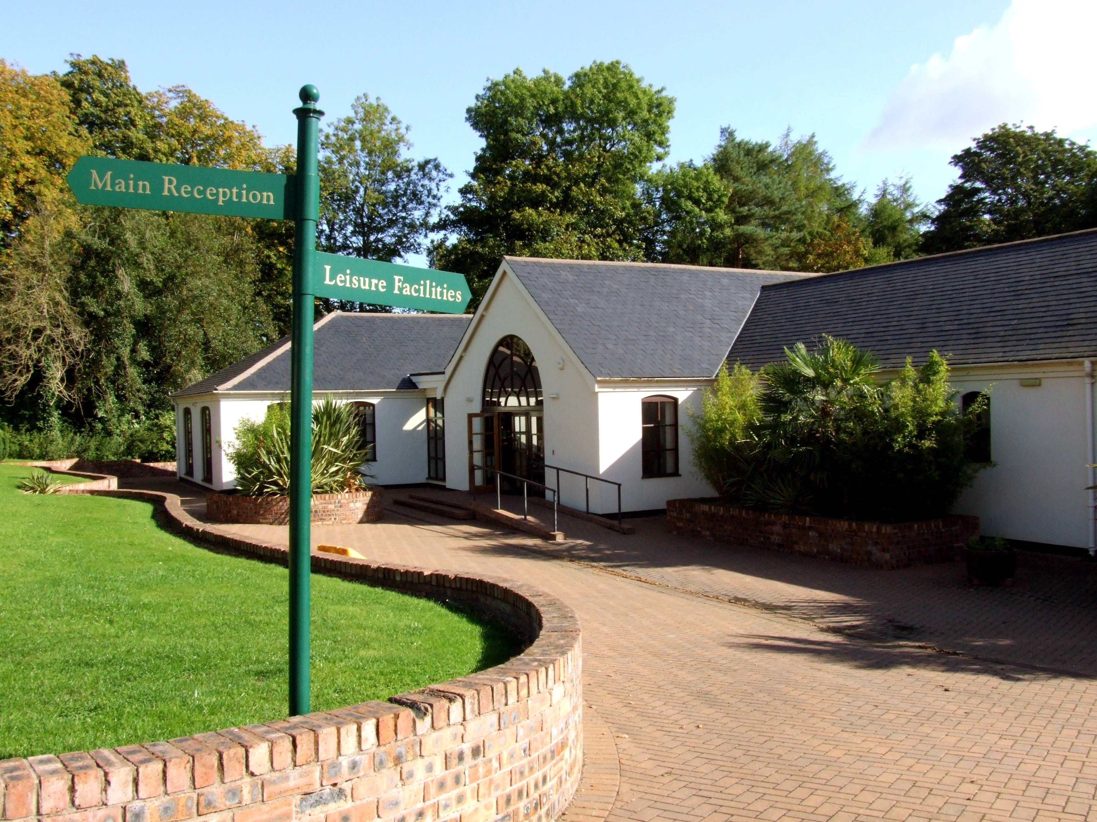 A building with a sign indicating 'Main Reception' and 'Leisure Facilities'.