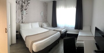 Standard Quadruple Room | Minibar, in-room safe, desk, soundproofing