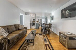 Suite, 2 Bedrooms (Up to 8pax) | Área de sala de estar | Televisión de pantalla plana de 23 pulgadas con canales por cable 