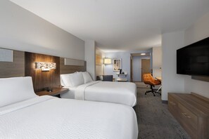 A hotel room with two beds, a desk, a chair, a TV, and a bathroom visible in the background. - Holiday Inn Express Savannah Airport by IHG (Savannah)