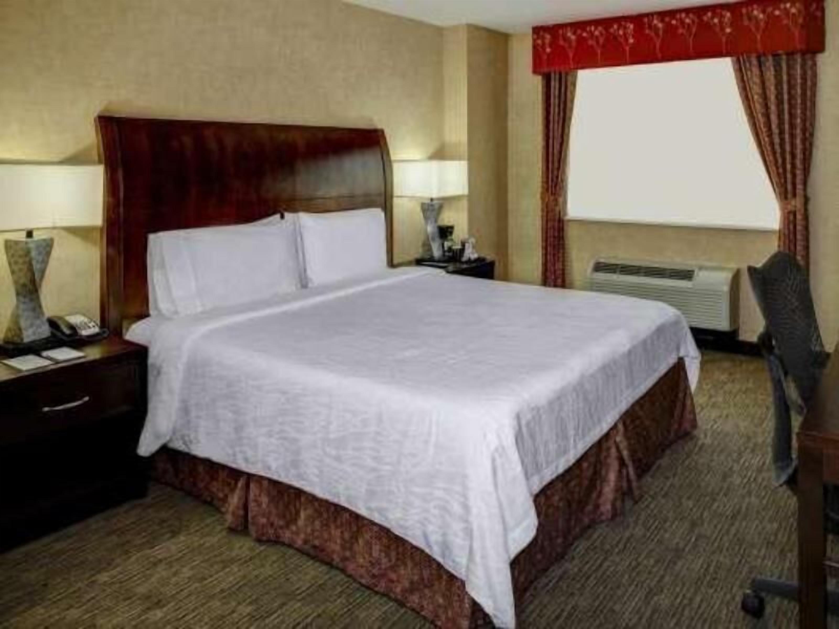 Premium bedding, desk, laptop workspace, blackout drapes