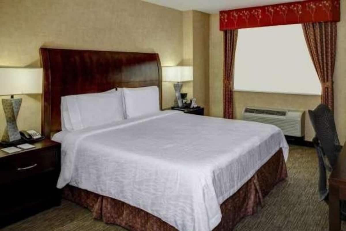 Premium bedding, desk, laptop workspace, blackout drapes