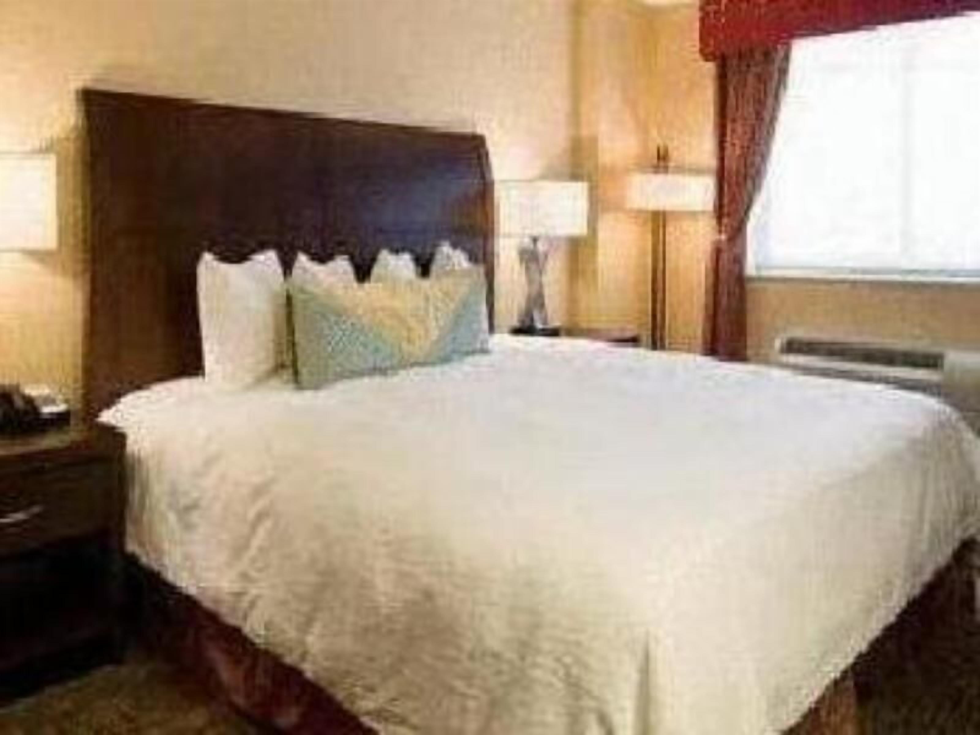 Premium bedding, desk, laptop workspace, blackout drapes