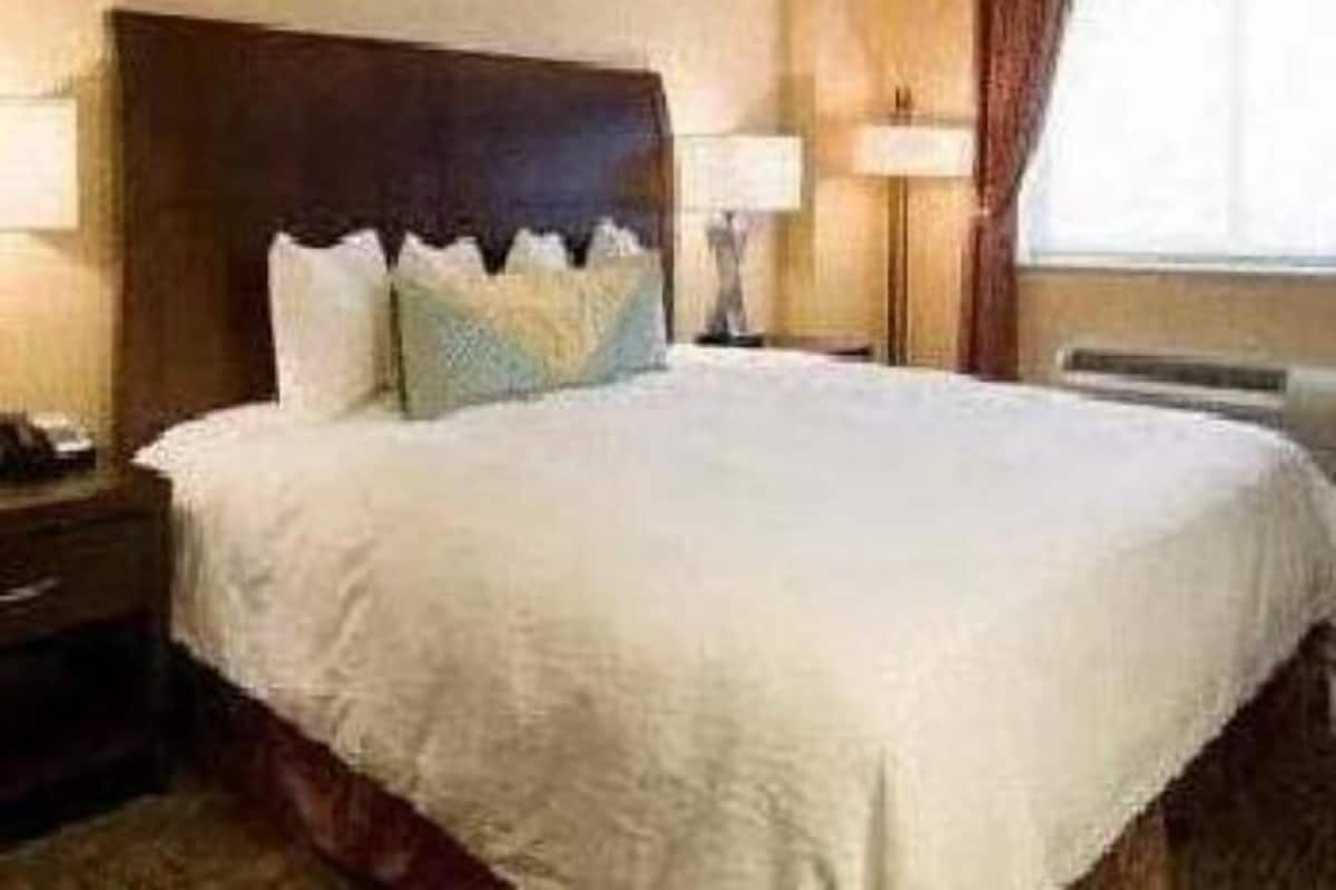 Premium bedding, desk, laptop workspace, blackout drapes