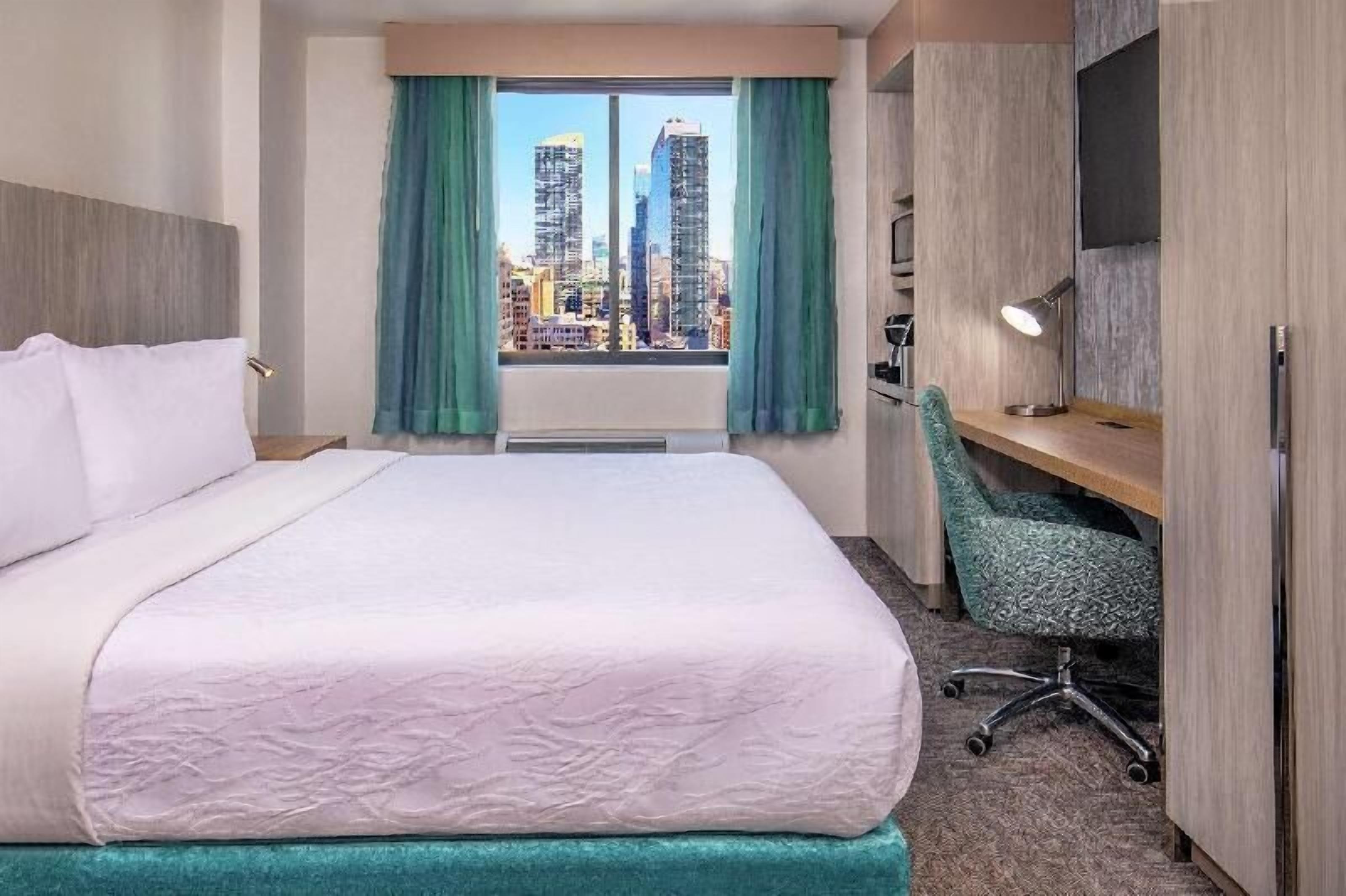 Premium bedding, desk, laptop workspace, blackout drapes