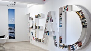 Un intérieur moderne avec une grande bibliothèque où les livres sont disposés de manière à former le mot « LIRE ».