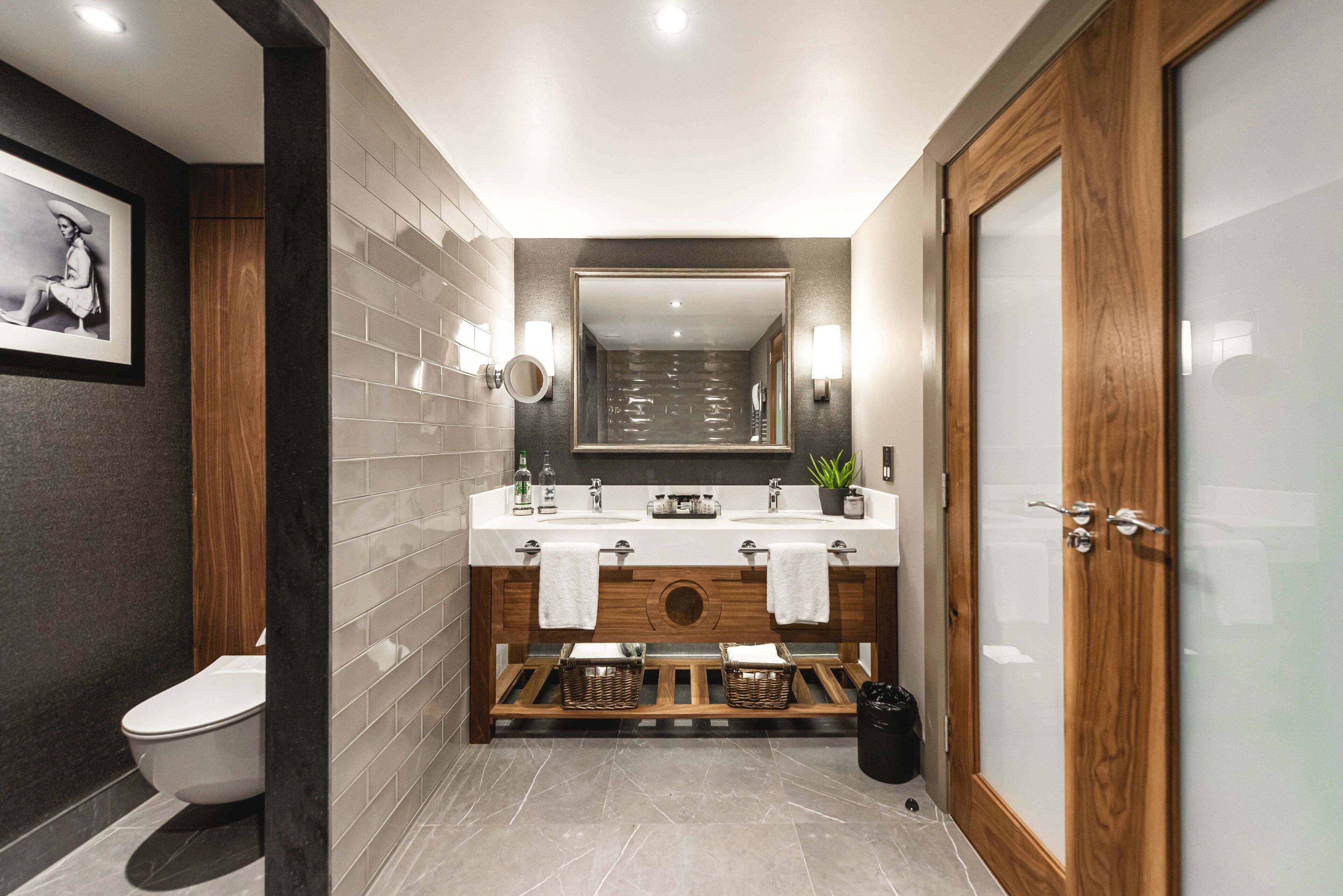 deluxe suite | bathroom | designer toiletries, hair dryer, towels, soap