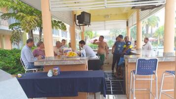 A covered outdoor area with a bar and seating.
