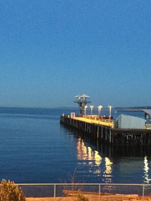 A pier extending into calm water with a small structure at the end. - Port Angeles Inn (Port Angeles)