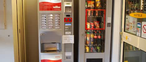 A vending machine with a coffee dispenser and a beverage cooler.