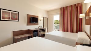 A hotel room with two beds, a desk with a television, a chair, a small table with a kettle, and a window with curtains. - Hotel Best Oasis Park (Salou)