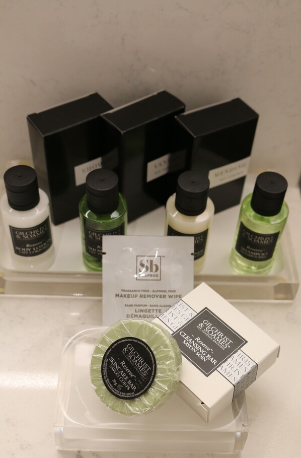 A display of skincare products including a green cleansing bar and various bottles of liquid soap.
