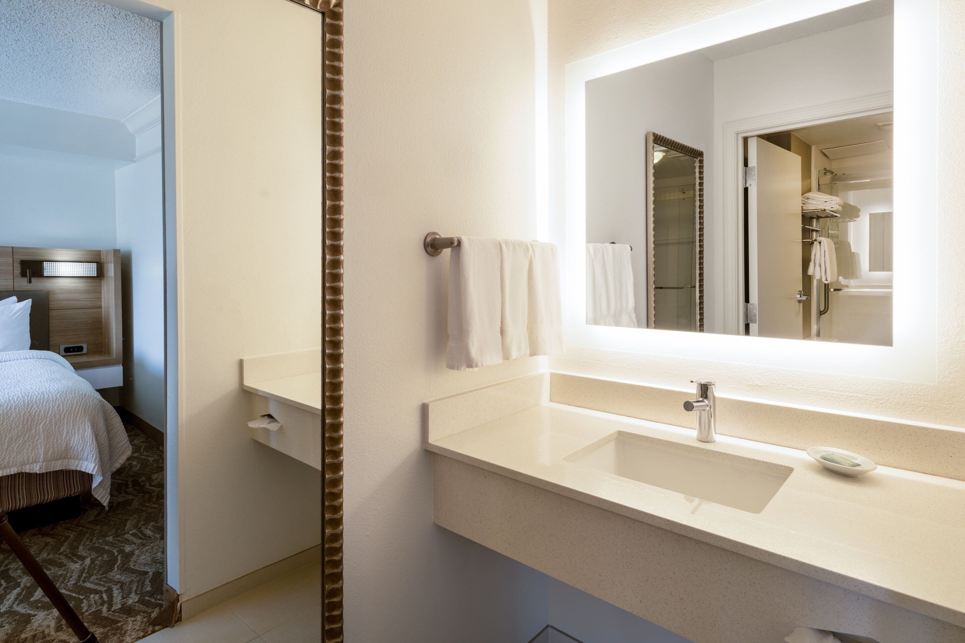 combined shower/bathtub, designer toiletries, hair dryer, towels