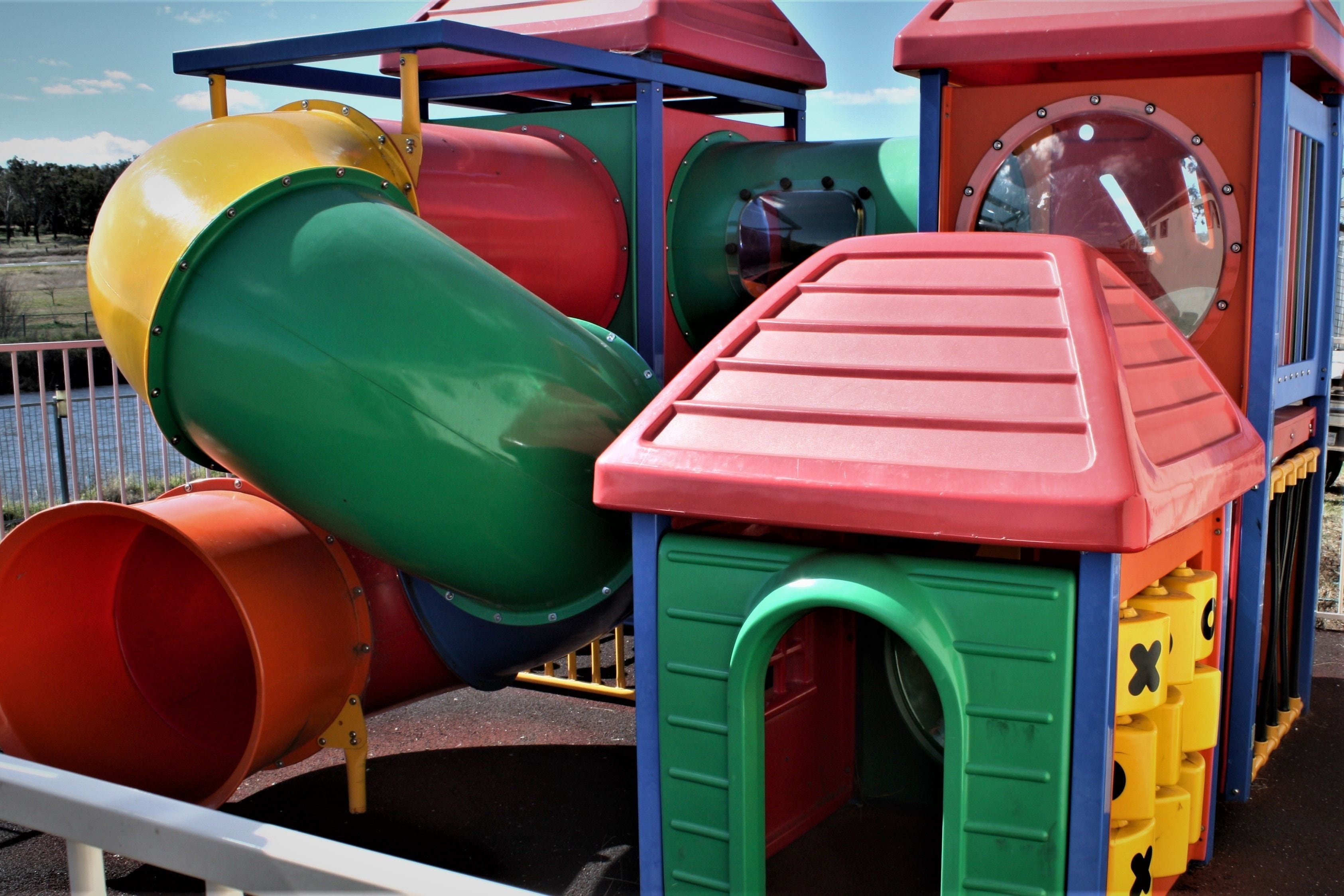 A colorful playground structure with slides and climbing elements.