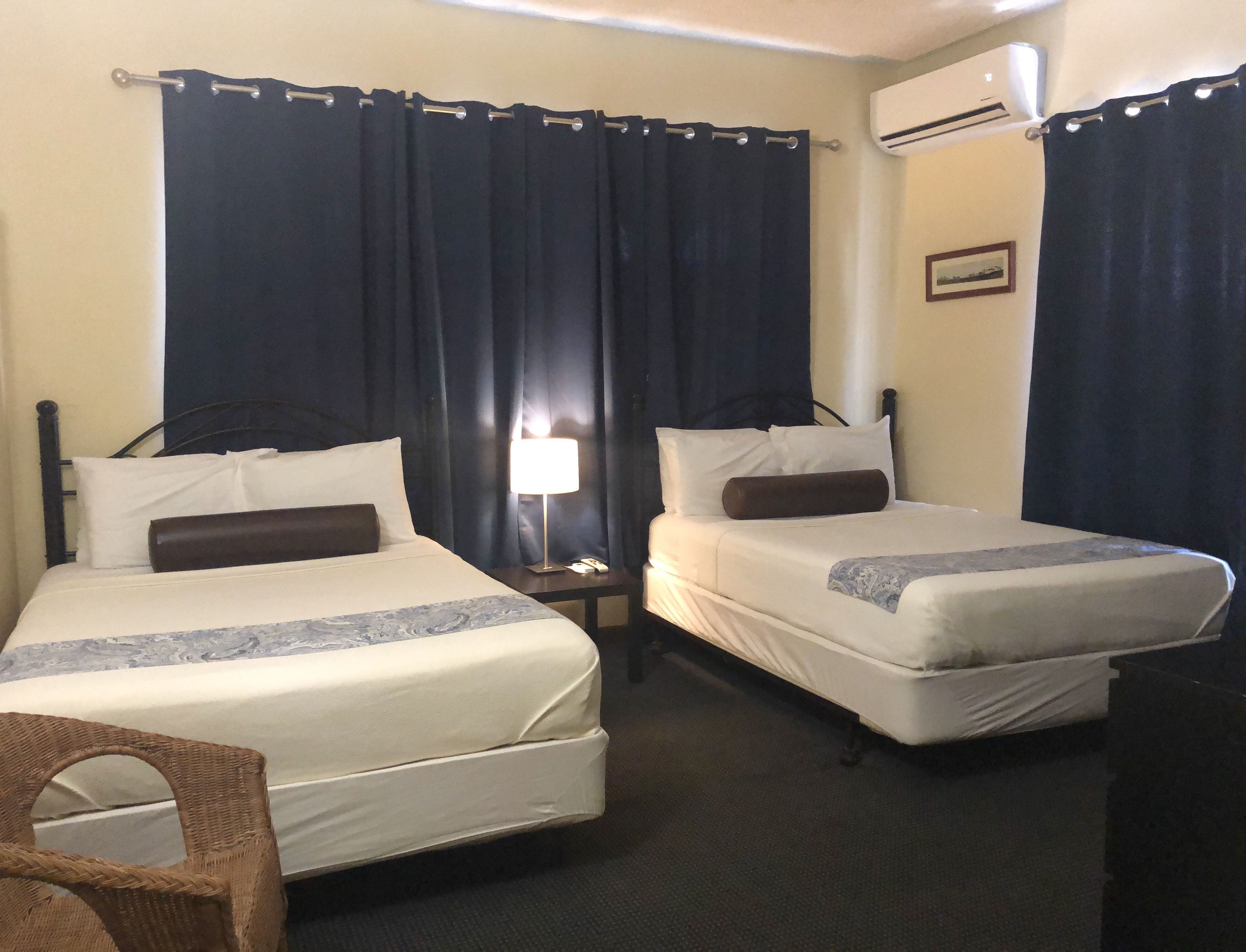 standard room with two double beds | 1 bedroom, in-room safe, iron/ironing board