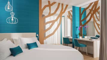 A modern bedroom with a large bed, a desk, and chairs.