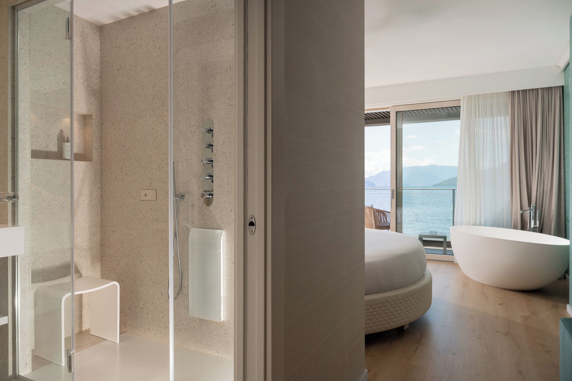 romantic double room, bathtub, lake view | bathroom | rainfall showerhead, hair dryer, towels, soap