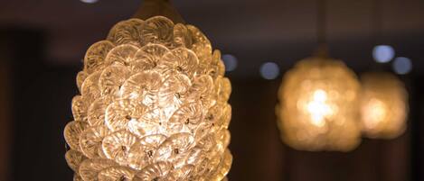 A close-up of a decorative glass light fixture with a spherical design.
