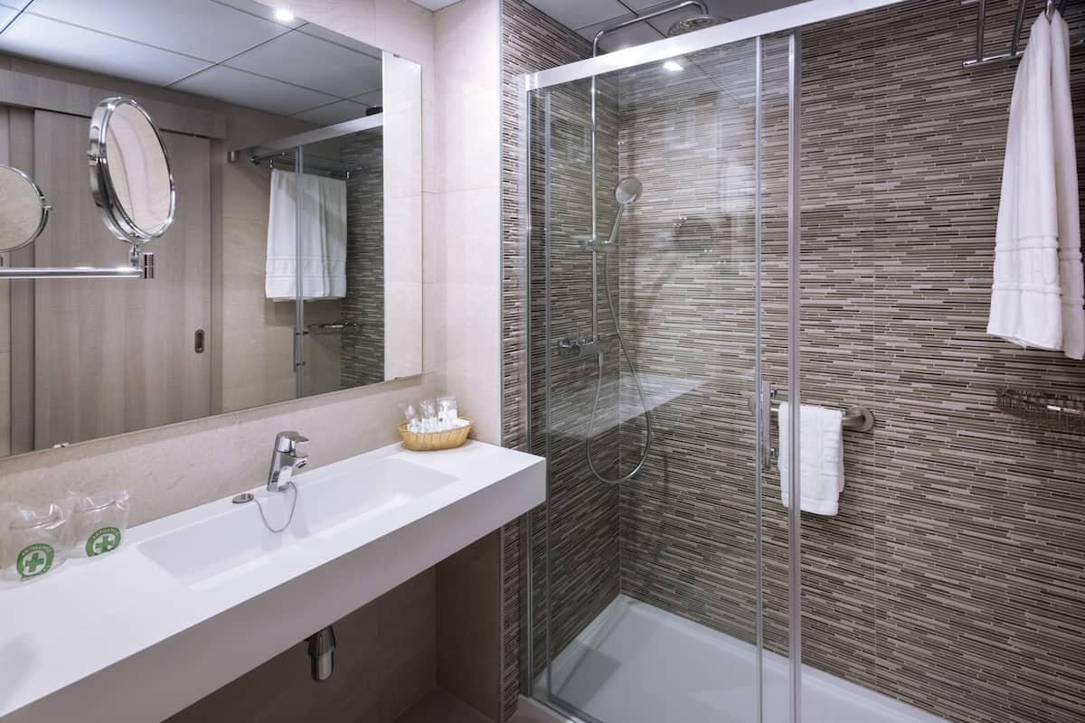 shower, designer toiletries, hair dryer, towels