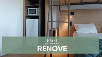 Desk, laptop workspace, blackout drapes, iron/ironing board