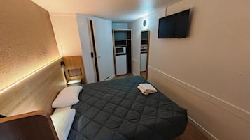 Desk, laptop workspace, blackout drapes, soundproofing