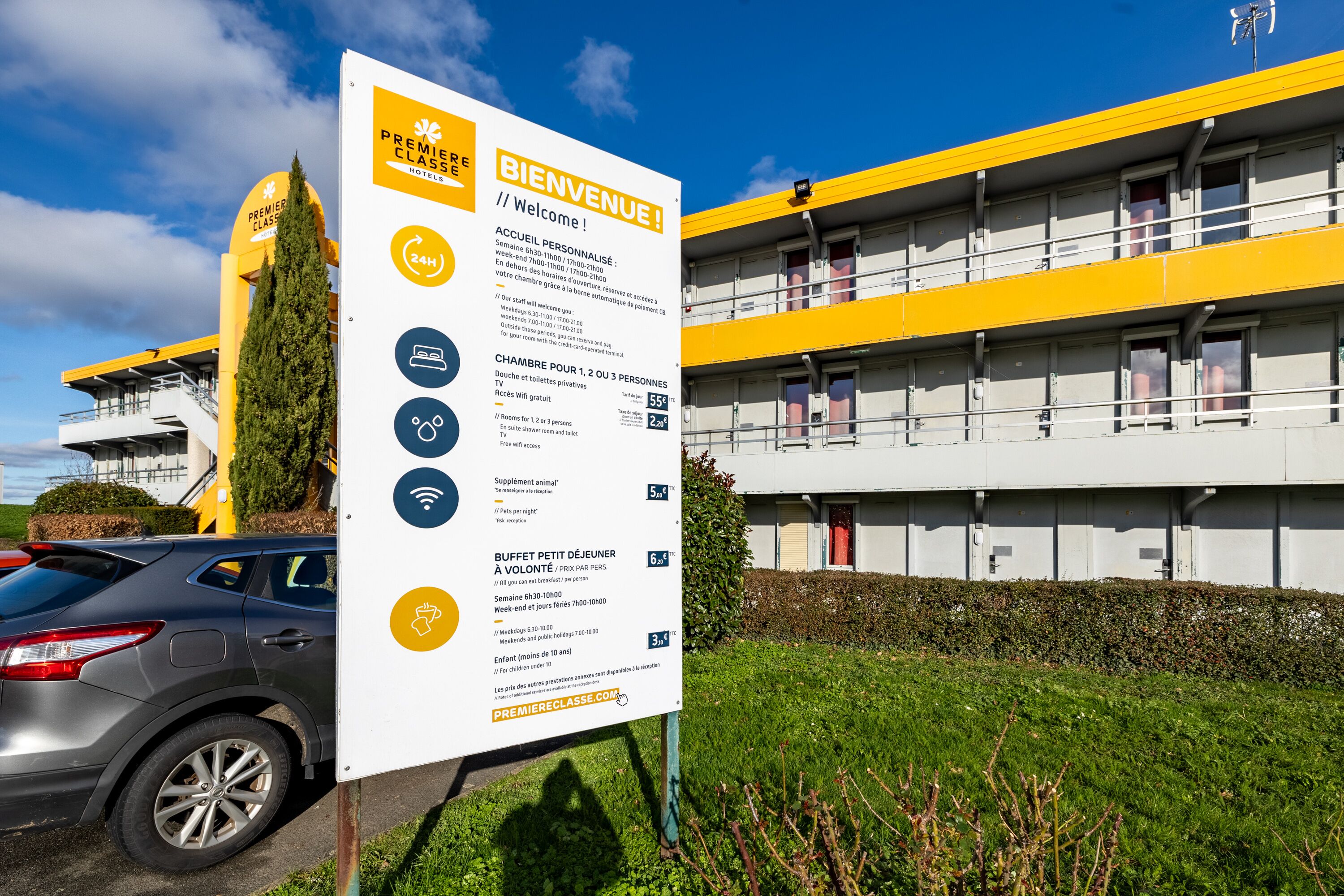 Ett hotellskylt som visar att hotellet erbjuder bekvämligheter som en reception öppen dygnet runt, privata rum och en liten buffé.