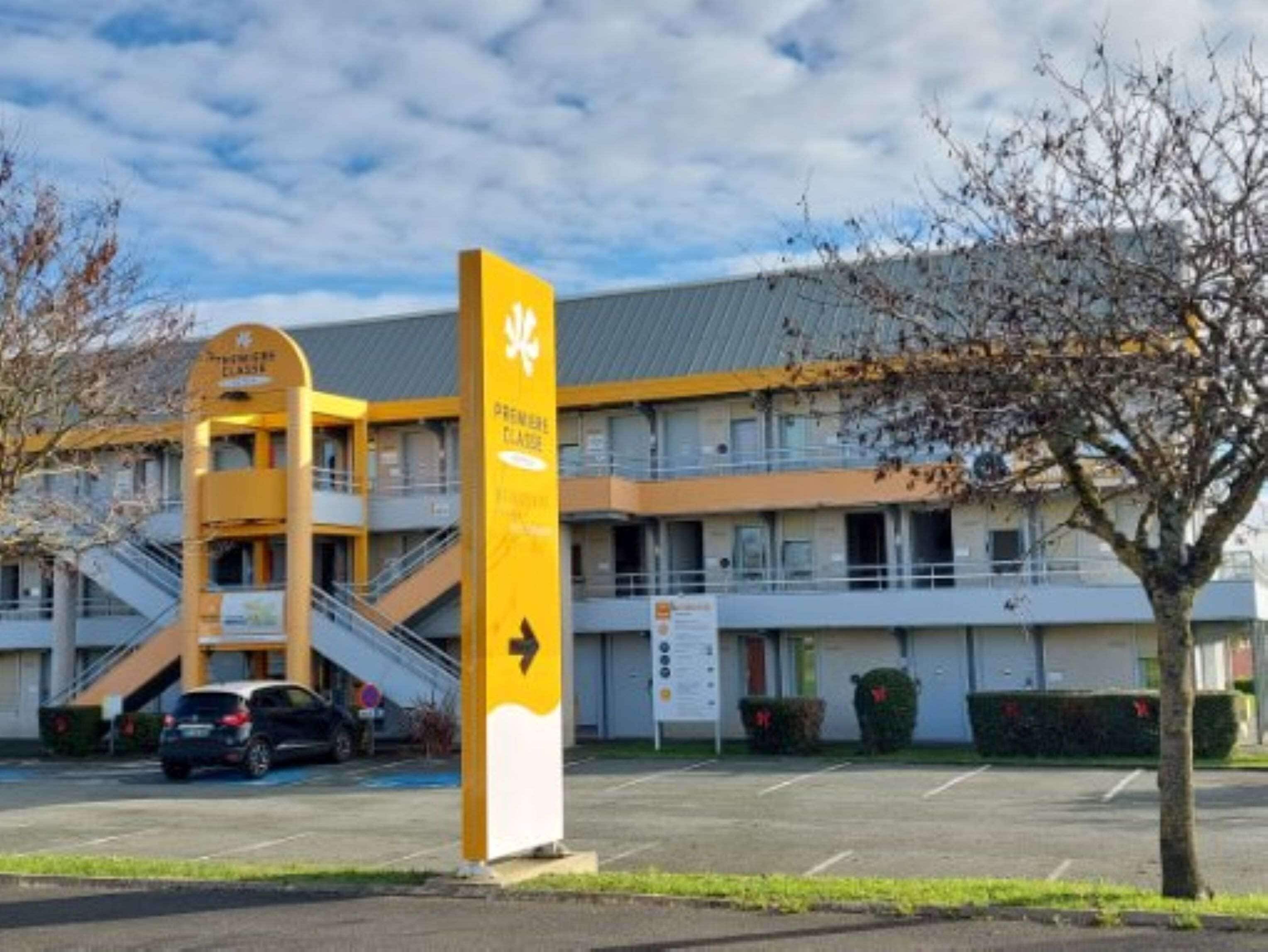 Un edificio con un letrero amarillo que indica una dirección.