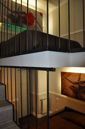 A staircase with black railings leading to an upper level. - Relais Palazzo Taverna (Rome)