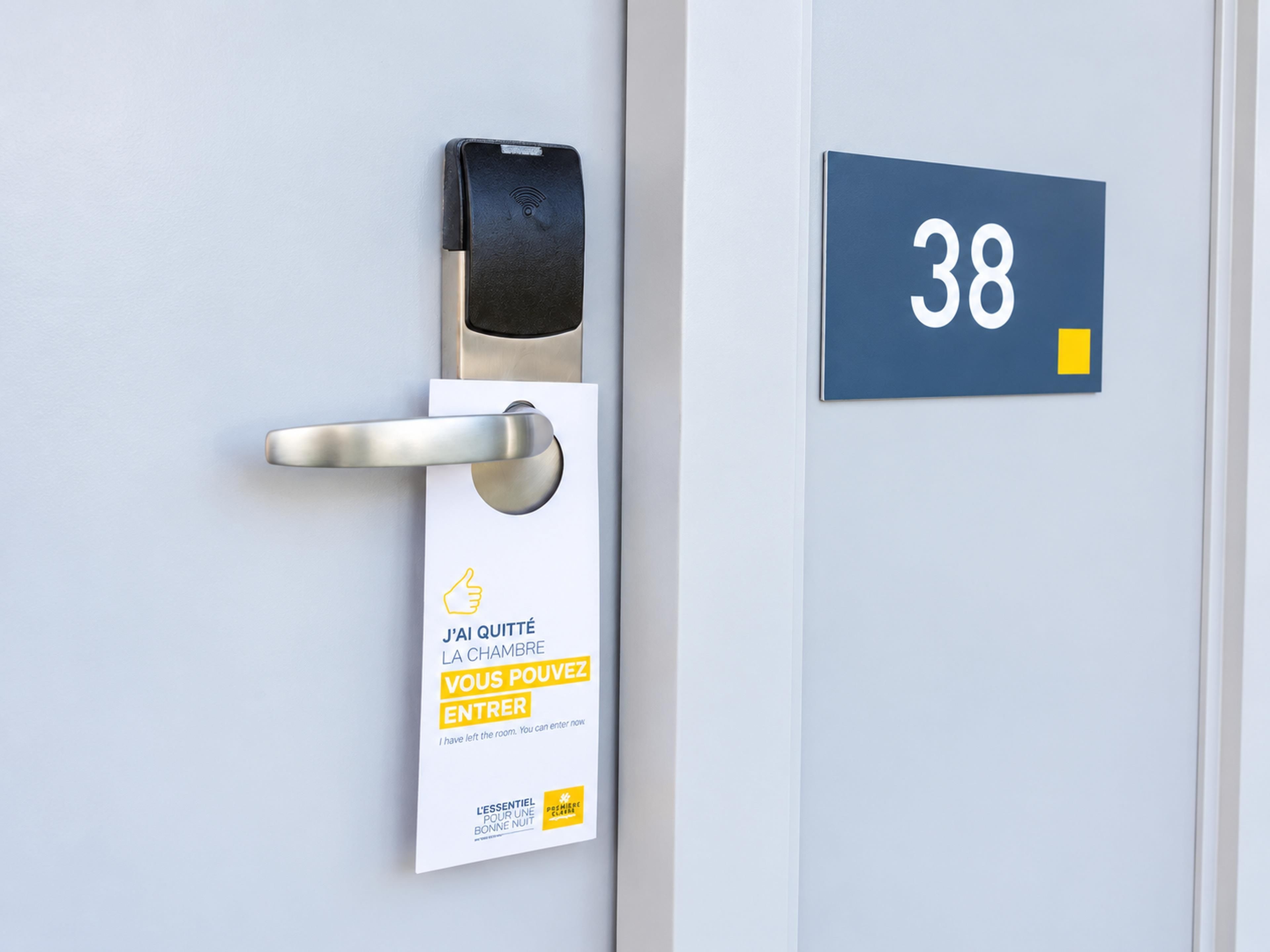A door with a digital lock and a sign indicating the room number 38.