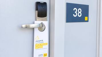 A door with a digital lock and a sign indicating the room number 38.
