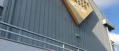 A hotel sign with the text "PREMIERE CLASSE HOTELS" on a building facade.
