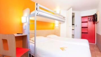 A bunk bed room with a desk and chair, a TV mounted on the wall, and a red storage unit.