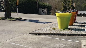A parking lot with large planters and a clear sky.