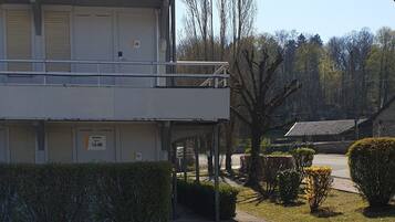 A multi-story building with a parking lot in front.