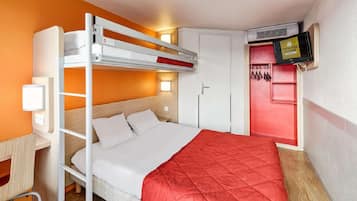 A bunk bed with a desk and chair, a television mounted on the wall, and a wardrobe with a red interior.